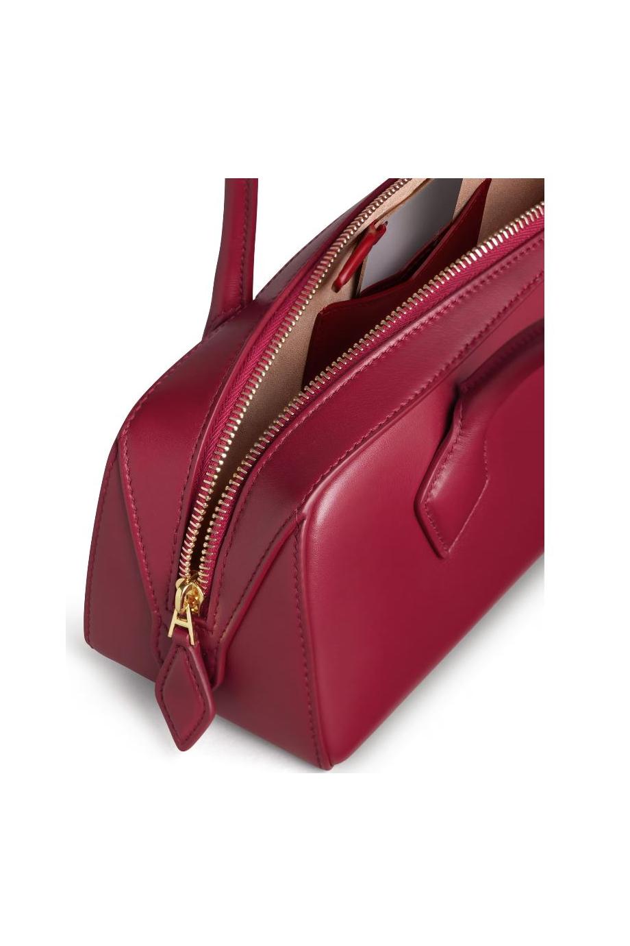 Le Teckel leather top handle bag in rouge carmin